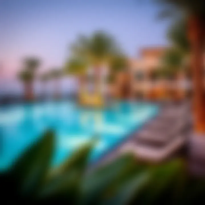 Luxurious swimming pool area surrounded by palm trees and sun loungers at Malibu Bay