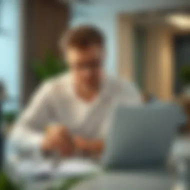 Focused individual analyzing financial data on a laptop